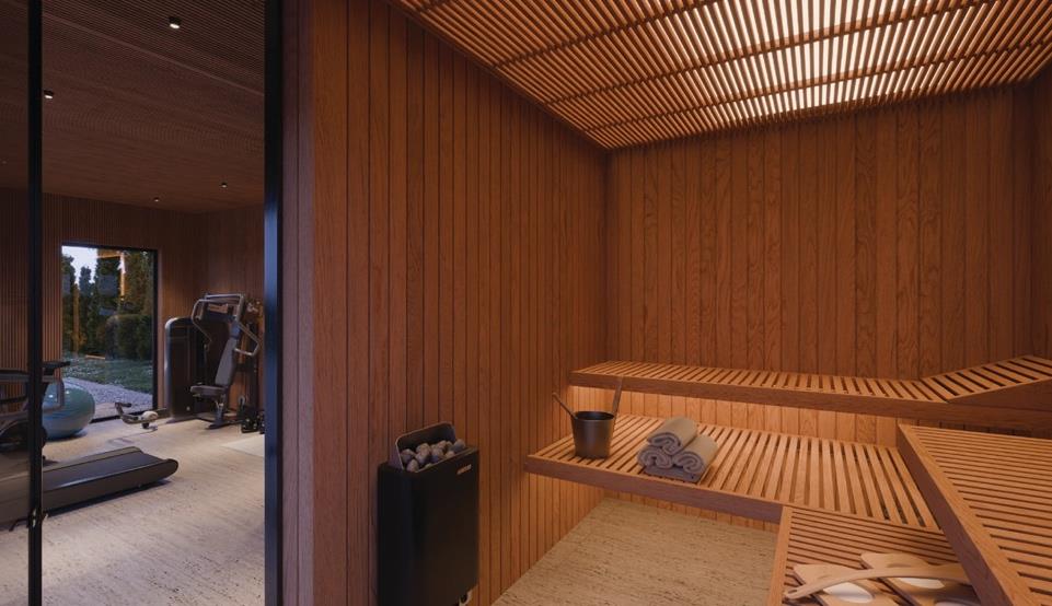 Sauna with wooden benches and heater looking into the gym.